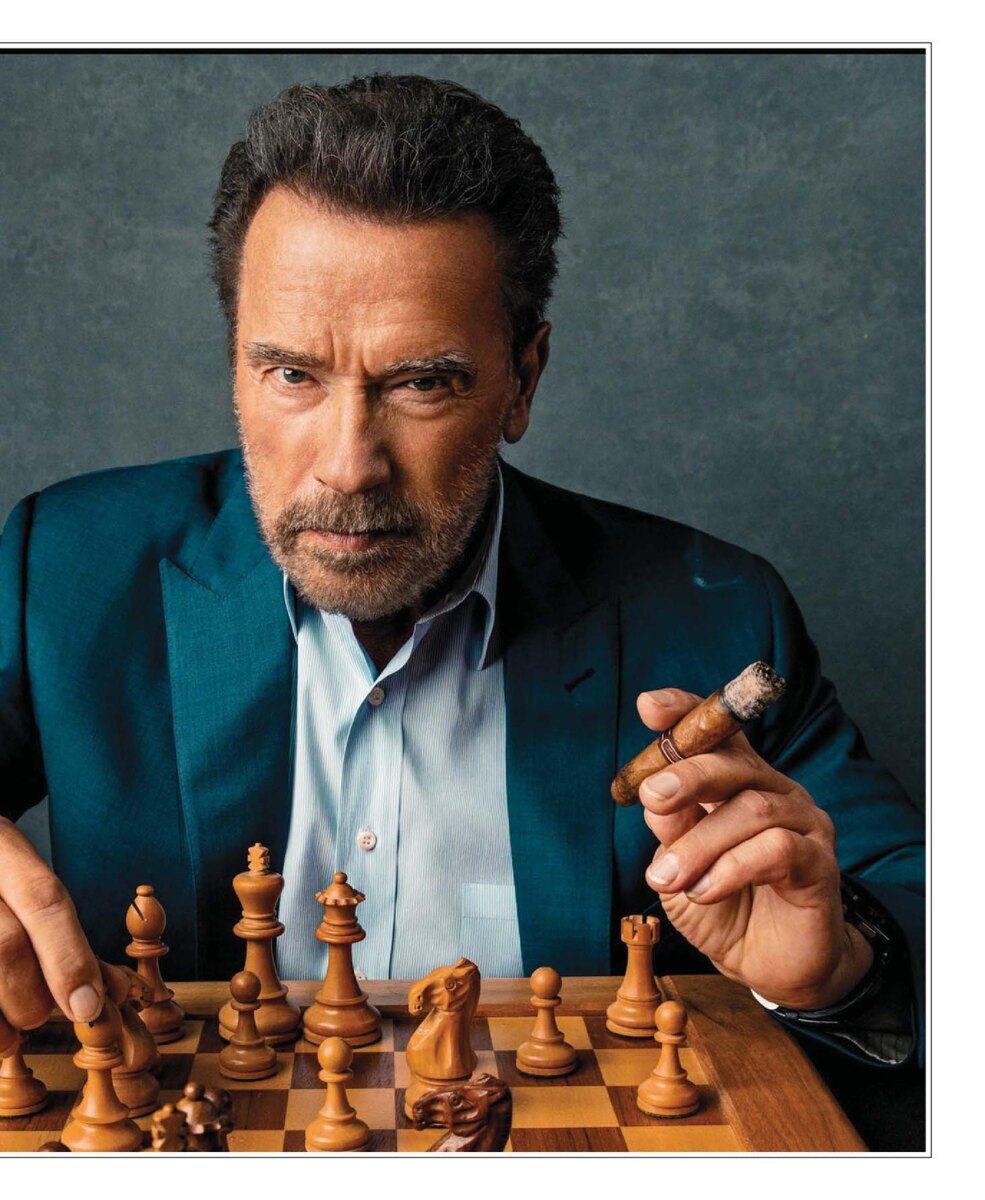 Arnold Schwarzenegger smoking a cigar during the interview